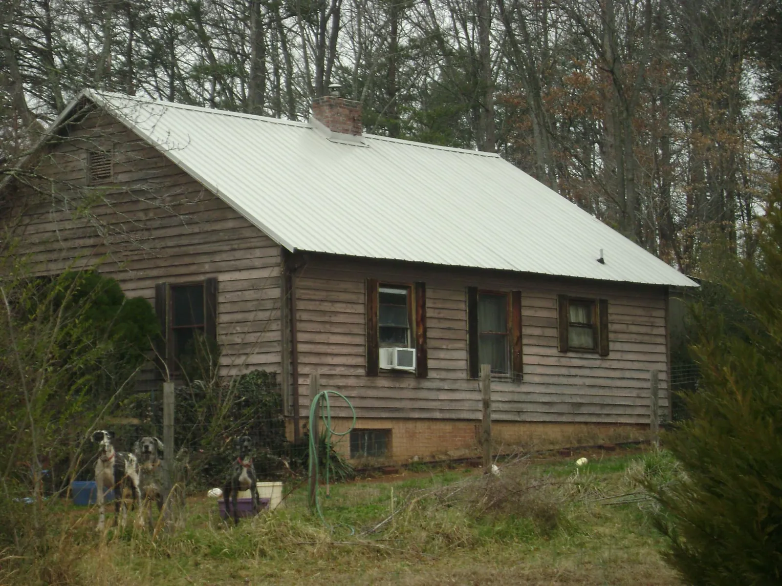 White metal roof on an old wood sided farmhouse, from a Metal Roof Installation job in Bowlus